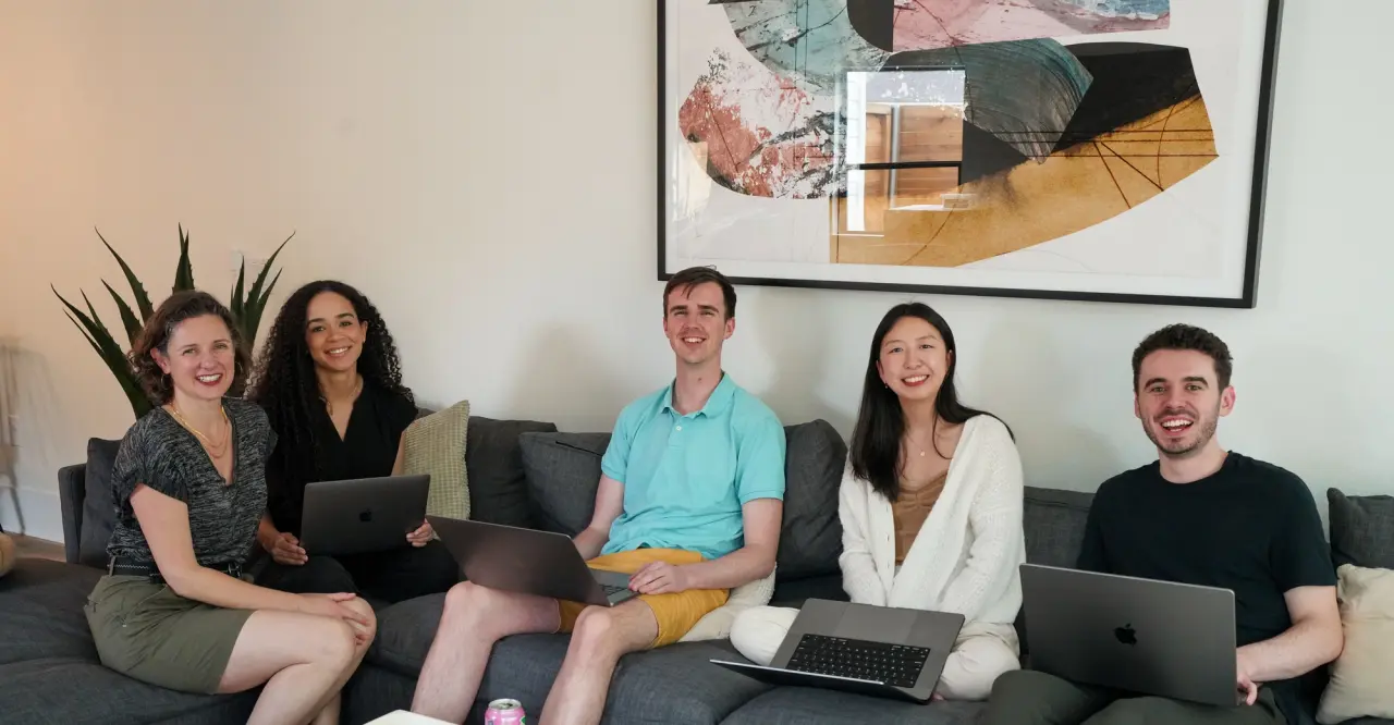 Pomelo engineers working together with laptops on a couch